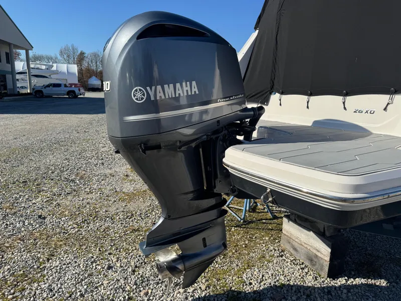 Slide: The Image of 2019 Regal 26 XO boat with Yamaha outboard motor in a gravel lot. - 9