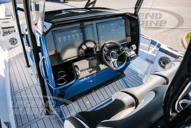 Slide: The Image of 2025 Nor-Tech 340 Sport boat dashboard with dual screens and modern steering wheel. - 11