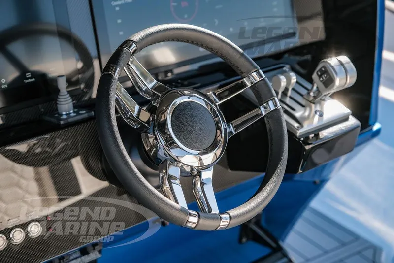 Slide: The Image of Steering wheel and controls of 2025 Nor-Tech 340 Sport boat. - 12