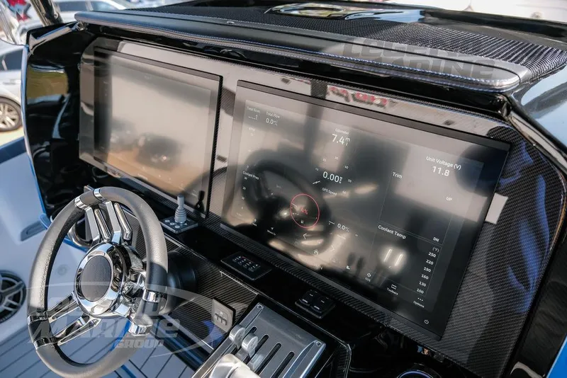 Slide: The Image of 2025 Nor-Tech 340 Sport dashboard with dual touchscreens and modern steering wheel. - 14