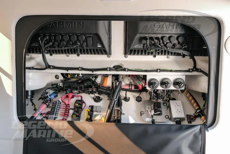 Slide: The Image of 2025 Nor-Tech 340 Sport boat electronics panel with Garmin systems and wiring. - 20