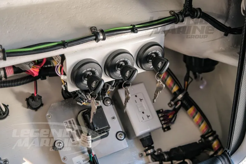 Slide: The Image of 2025 Nor-Tech 340 Sport boat ignition system with keys and wiring. - 22