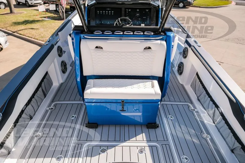 Slide: The Image of 2025 Nor-Tech 340 Sport boat interior with blue and white seating and modern dashboard. - 26