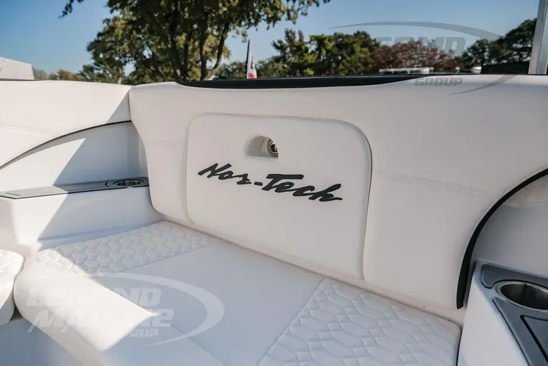 Slide: The Image of 2025 Nor-Tech 340 Sport boat interior with white seating and logo detail. - 39