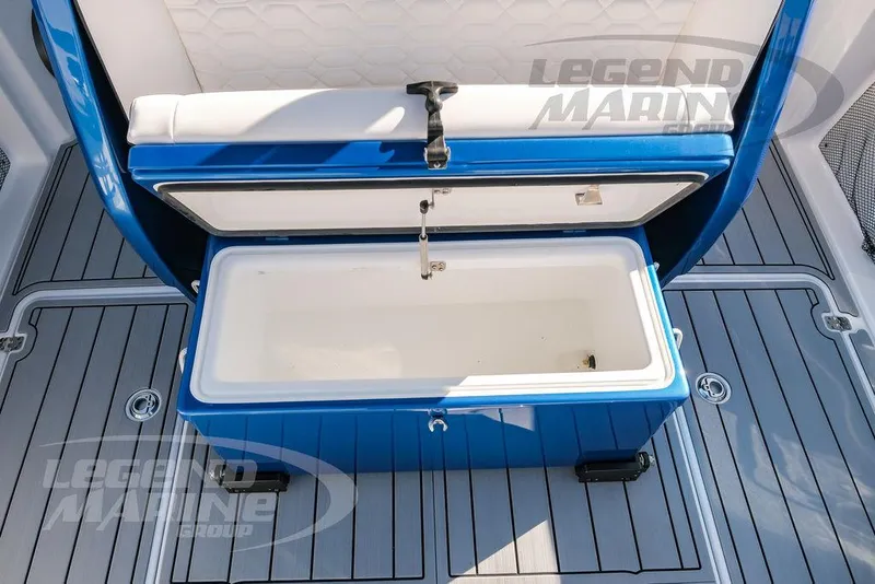 Slide: The Image of Open storage compartment on 2025 Nor-Tech 340 Sport boat, featuring blue and white design. - 45