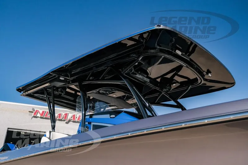 Slide: The Image of 2025 Nor-Tech 340 Sport boat with sleek black T-top against clear blue sky. - 46