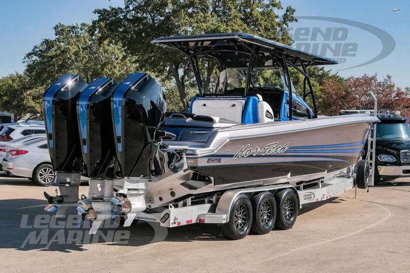 Slide: The Image of 2025 Nor-Tech 340 Sport boat with triple engines on a trailer. - 5