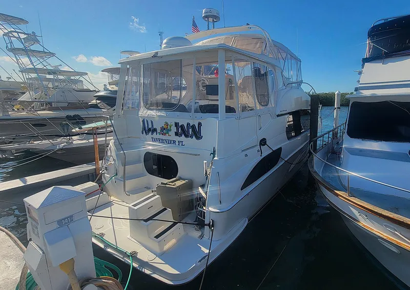 Slide: The Image of 2005 Silverton 43 Motor Yacht docked at marina, sunny day. - 1
