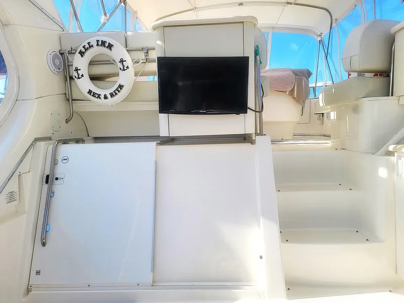 Slide: The Image of 2005 Silverton 43 Motor Yacht interior with TV, seating, and life preserver. - 11