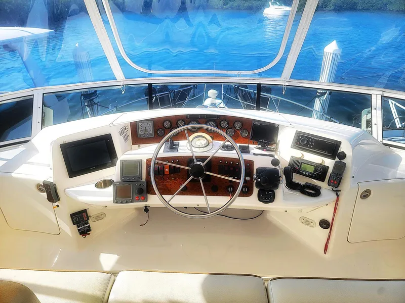 Slide: The Image of Helm of 2005 Silverton 43 Motor Yacht with navigational instruments and steering wheel. - 13