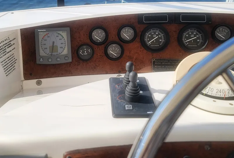 Slide: The Image of Dashboard of a 2005 Silverton 43 Motor Yacht with gauges and controls. - 15
