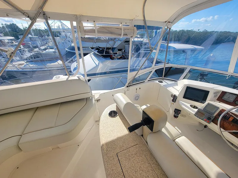 Slide: The Image of Interior view of 2005 Silverton 43 Motor Yacht helm with seating and navigation equipment. - 17