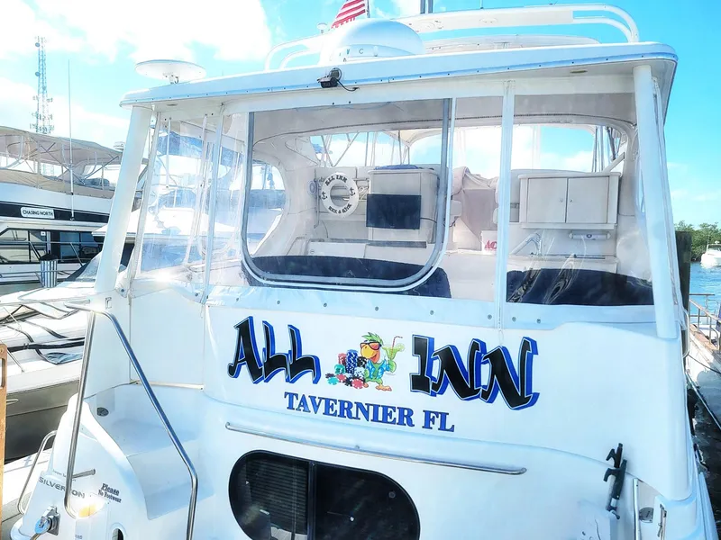 Slide: The Image of 2005 Silverton 43 Motor Yacht docked in Tavernier, FL, with "All Inn" signage. - 21