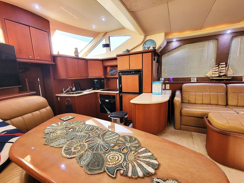 Slide: The Image of Luxurious interior of 2005 Silverton 43 Motor Yacht with elegant wood finishes and cozy seating. - 3