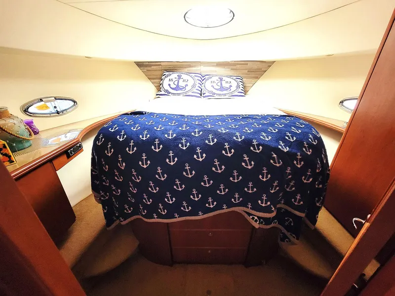 Slide: The Image of Cozy bedroom in 2005 Silverton 43 Motor Yacht with nautical-themed decor. - 5