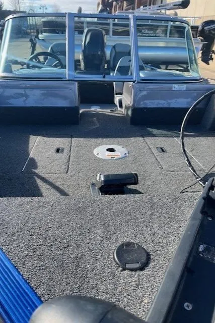 Slide: The Image of 2014 Lowe Fishing Machine FM165WT boat interior with seating and deck view. - 6