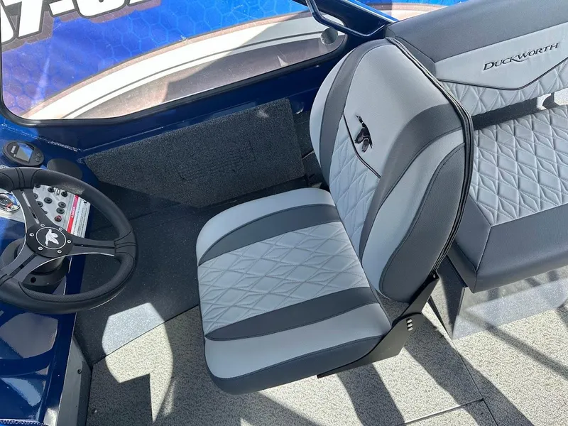 Slide: The Image of 2025 Duckworth 18 Advantage boat interior with gray and black seating and steering wheel. - 12
