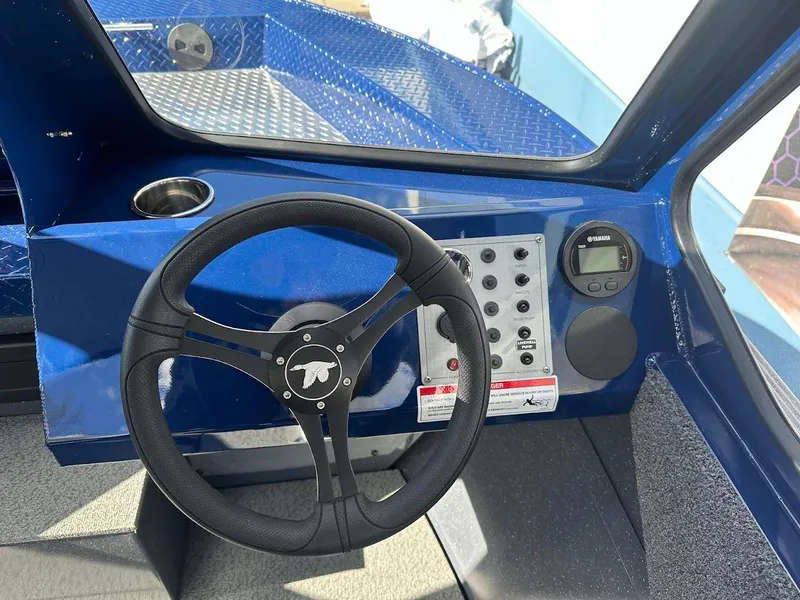 Slide: The Image of 2025 Duckworth 18 Advantage boat dashboard with steering wheel and control panel. - 13