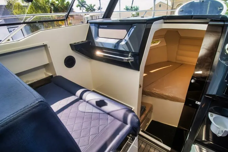 Slide: The Image of Interior of 2024 Skamander 920 Explorer Max boat, featuring seating and cabin area. - 19
