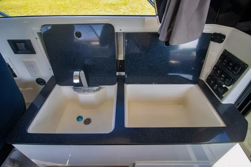 Slide: The Image of 2024 Skamander 920 Explorer Max kitchen sink area with modern fixtures. - 20