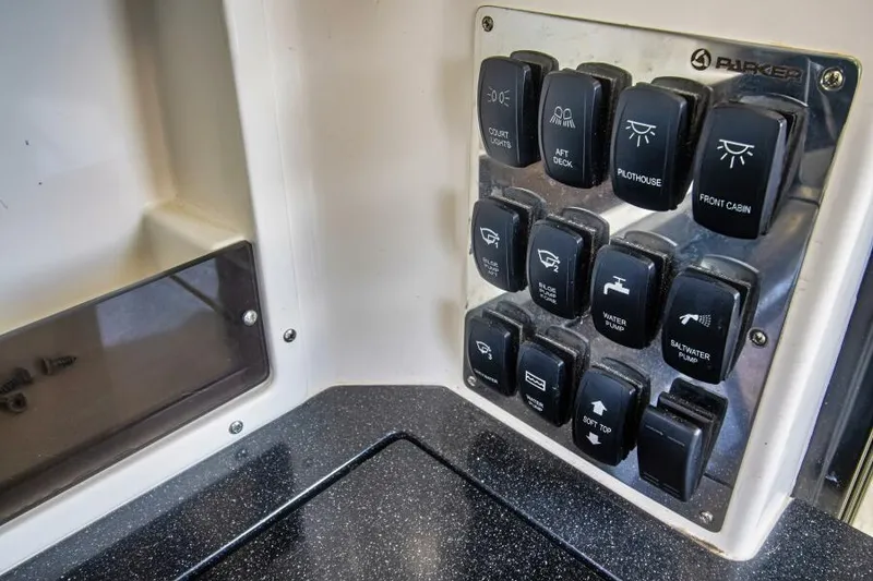 Slide: The Image of Control panel of 2024 Skamander 920 Explorer Max boat with labeled switches. - 21