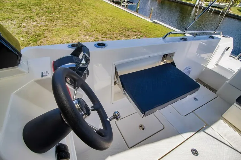 Slide: The Image of 2024 Skamander 920 Explorer Max boat interior with steering wheel and seating area. - 38