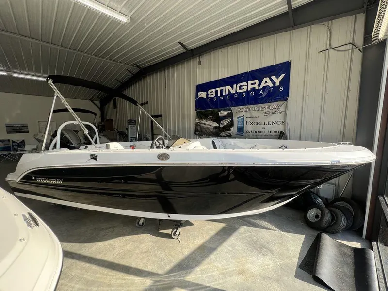 The Image of 2025 Stingray 172SC boat in showroom, black and white design, under indoor lighting. - 1