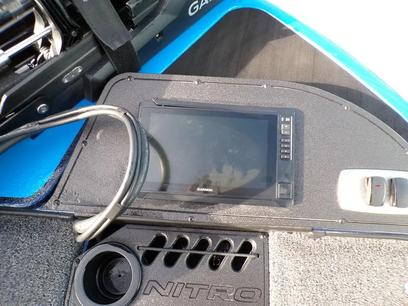 Slide: The Image of Nitro Z18 Pro 2025 dashboard with Garmin display and cup holder. - 10