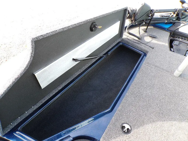 Slide: The Image of 2025 Nitro Z18 Pro boat storage compartment with open lid and carpeted interior. - 18