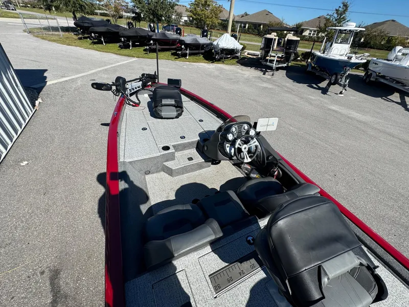 Slide: The Image of 2020 Bass Tracker 175 TF boat with red trim, parked outdoors in a lot. - 11