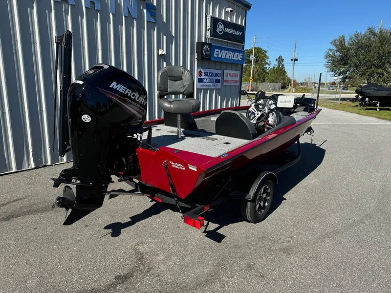 Slide: The Image of 2020 Bass Tracker 175 TF boat with Mercury engine, parked outdoors. - 14