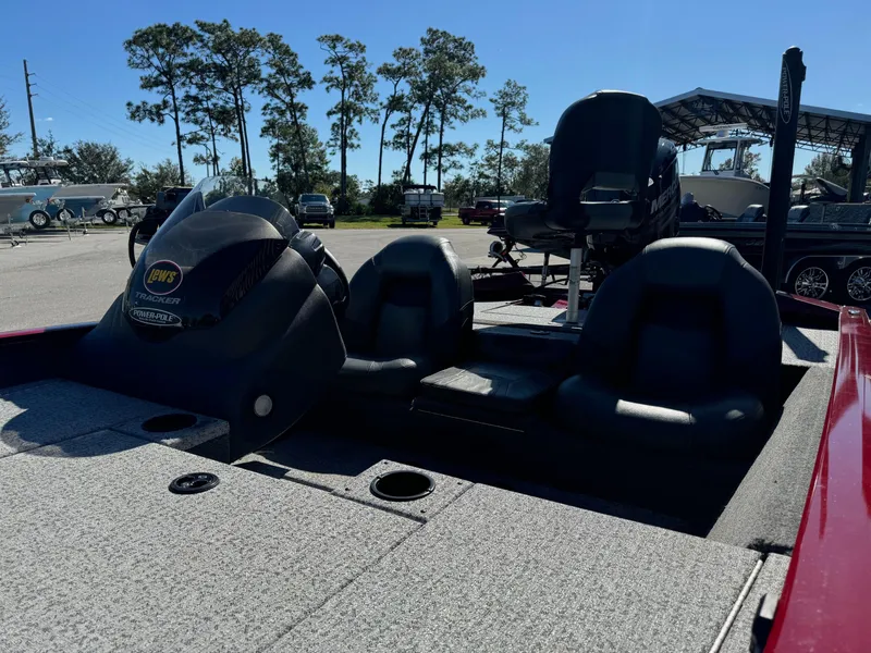 Slide: The Image of 2020 Bass Tracker 175 TF boat with seating and motor, parked outdoors. - 7