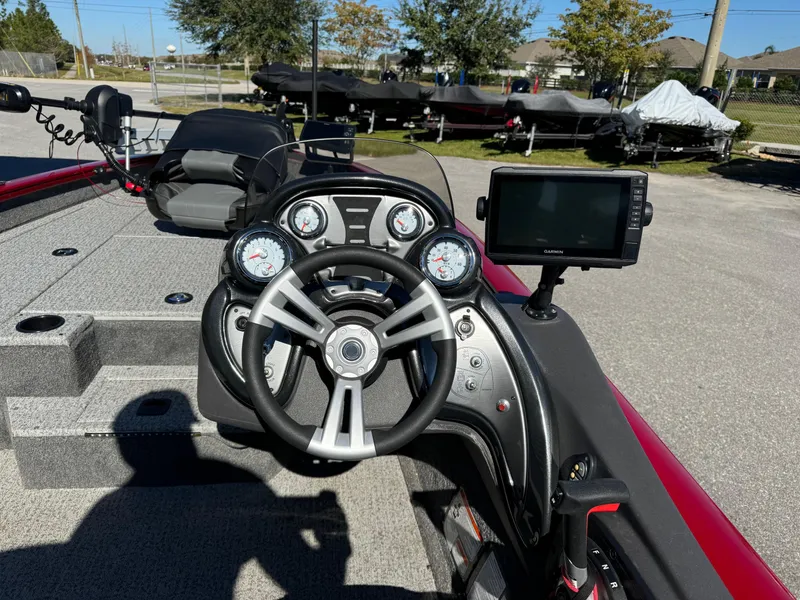 Slide: The Image of 2020 Bass Tracker 175 TF boat dashboard with steering wheel and navigation system. - 9