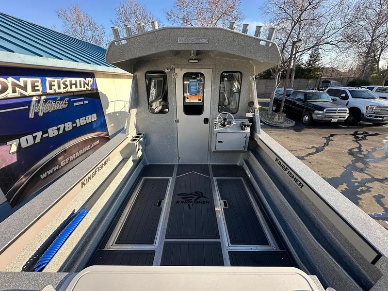 Slide: The Image of 2025 KingFisher 2625 Coastal Express boat, spacious deck, parked outdoors. - 14