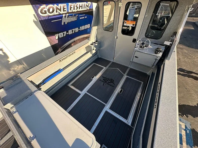 Slide: The Image of 2025 KingFisher 2625 Coastal Express boat interior with steering wheel and seating area. - 16
