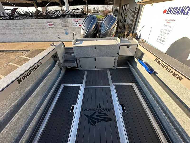Slide: The Image of 2025 KingFisher 2625 Coastal Express boat interior with dual engines and branded flooring. - 17