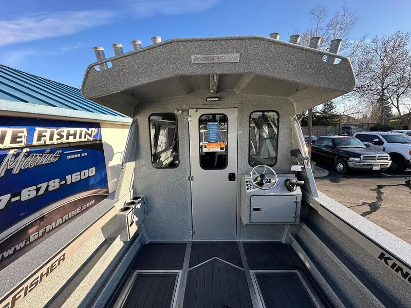 Slide: The Image of 2025 KingFisher 2625 Coastal Express boat interior with steering console and cabin view. - 24