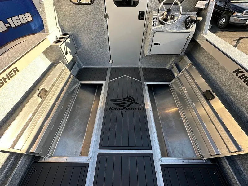 Slide: The Image of 2025 KingFisher 2625 Coastal Express boat interior with storage compartments and steering console. - 25
