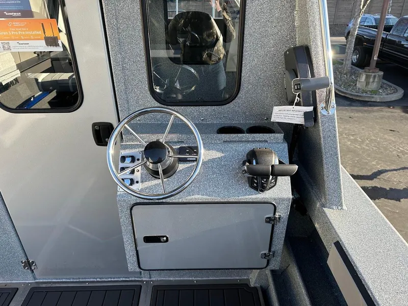 Slide: The Image of 2025 KingFisher 2625 Coastal Express boat interior with steering wheel and controls. - 26