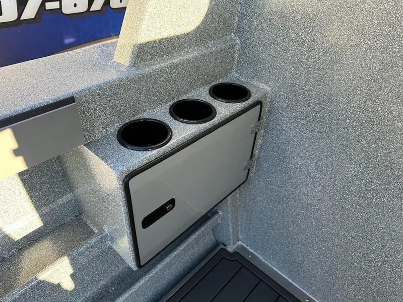 Slide: The Image of KingFisher 2625 Coastal Express 2025 boat interior with cup holders and storage compartment. - 28