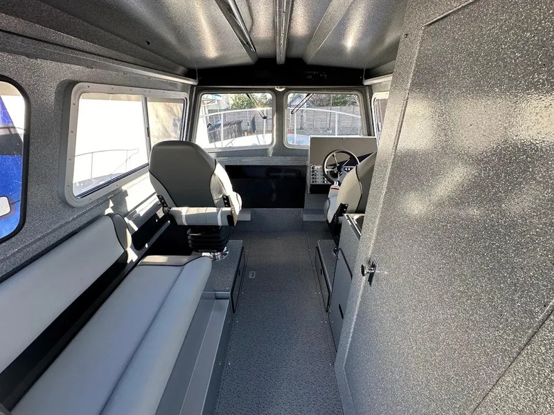 Slide: The Image of Interior of 2025 KingFisher 2625 Coastal Express boat, featuring seating and steering area. - 31