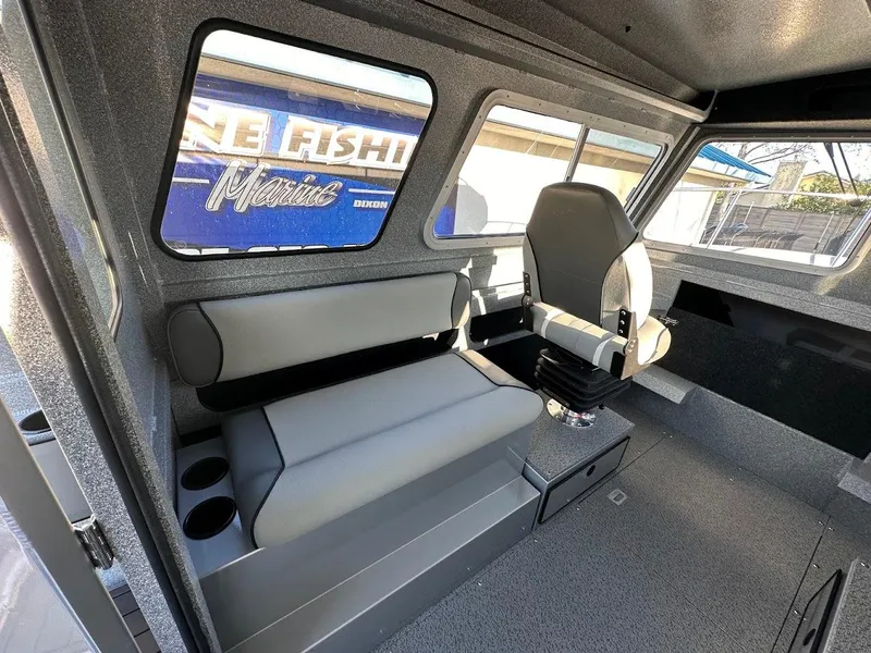 Slide: The Image of Interior of 2025 KingFisher 2625 Coastal Express boat, featuring seating and windows. - 32
