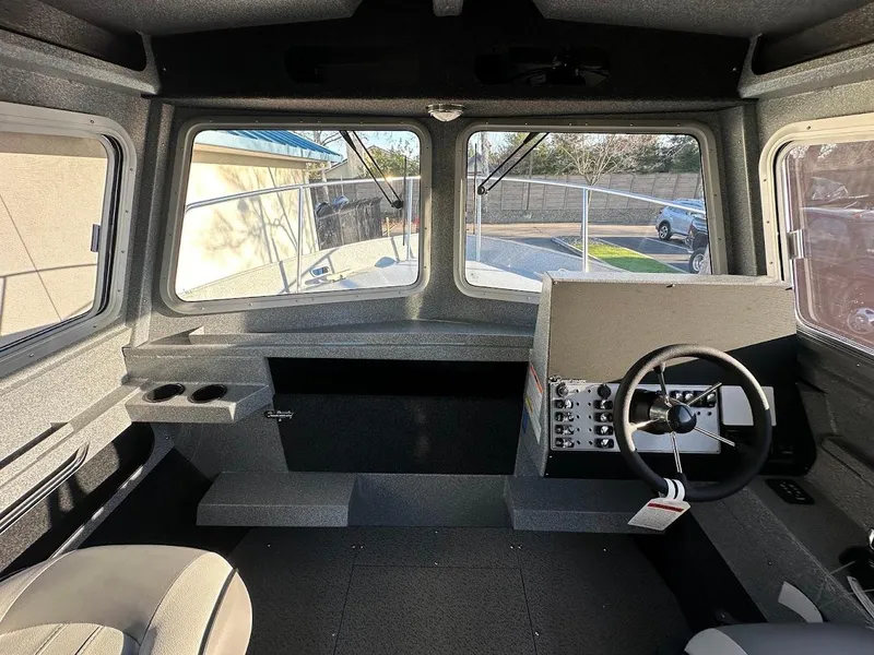Slide: The Image of Interior of 2025 KingFisher 2625 Coastal Express boat, featuring steering wheel and dashboard. - 33