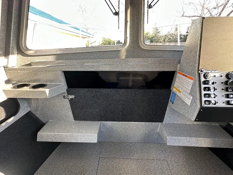 Slide: The Image of Interior of 2025 KingFisher 2625 Coastal Express boat, featuring control panel and seating area. - 35