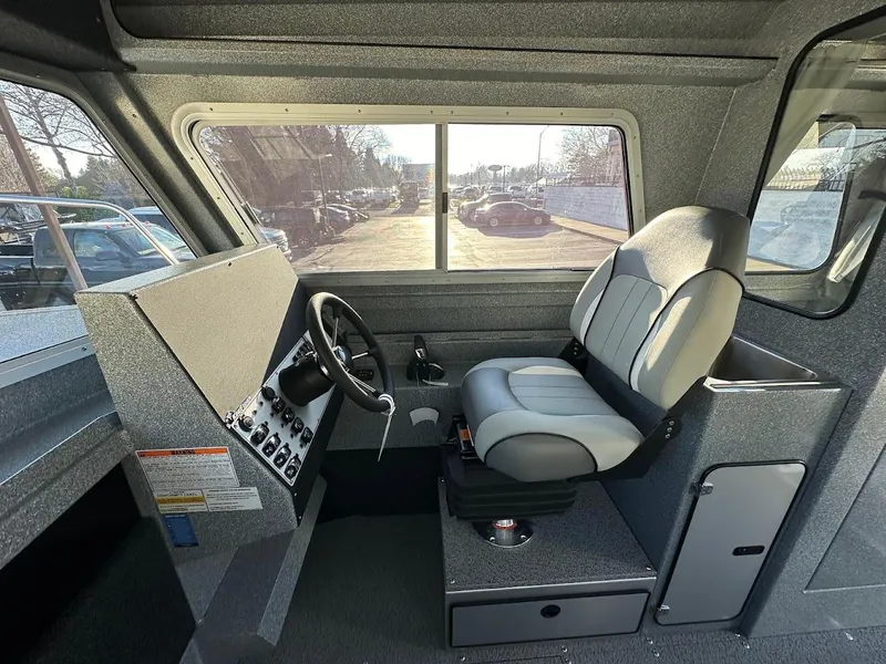 Slide: The Image of Interior of 2025 KingFisher 2625 Coastal Express boat, featuring helm and captain's chair. - 37