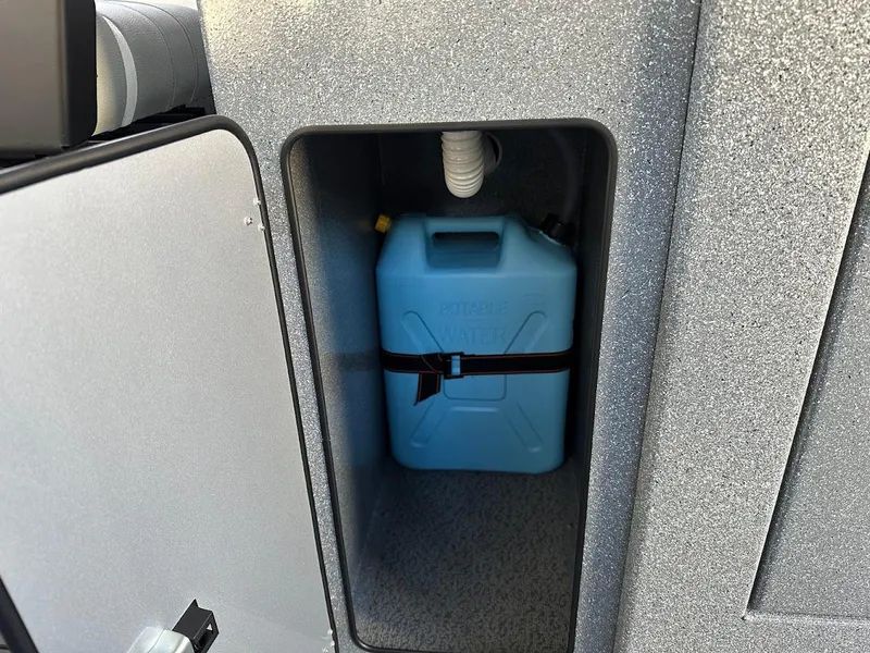 Slide: The Image of Blue water container inside KingFisher 2625 Coastal Express 2025 storage compartment. - 44