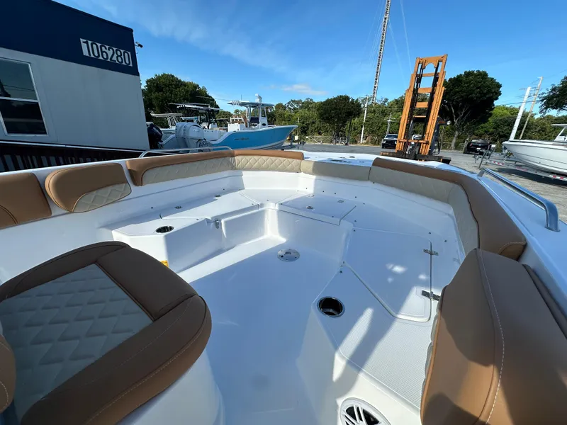 Slide: The Image of 2025 NauticStar 231 Hybrid boat interior with tan seating and spacious deck. - 14