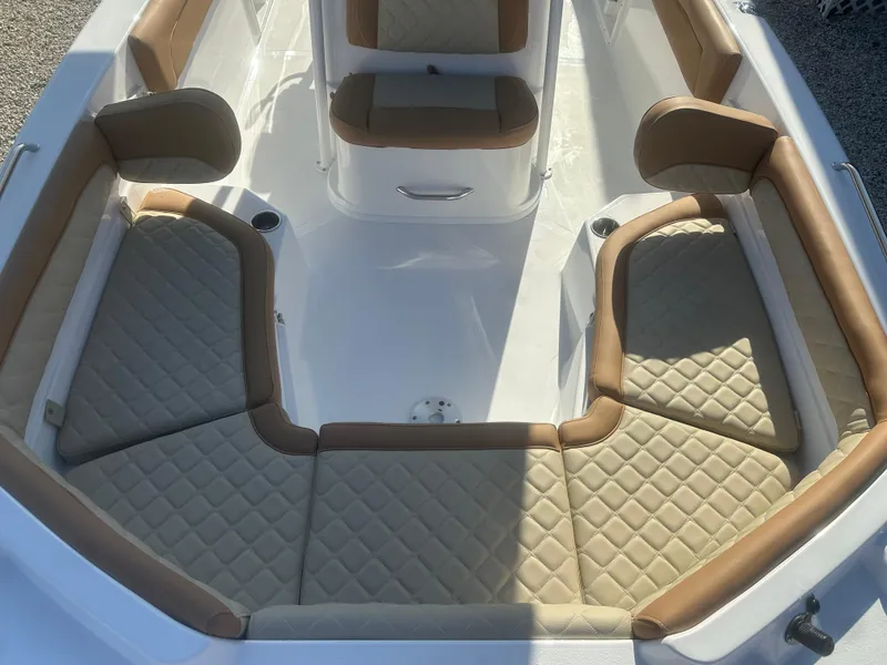 Slide: The Image of 2025 NauticStar 231 Hybrid boat interior with tan and white cushioned seating. - 17