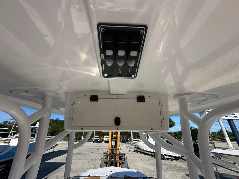 Slide: The Image of 2025 NauticStar 231 Hybrid boat console with control panel and storage compartment. - 26