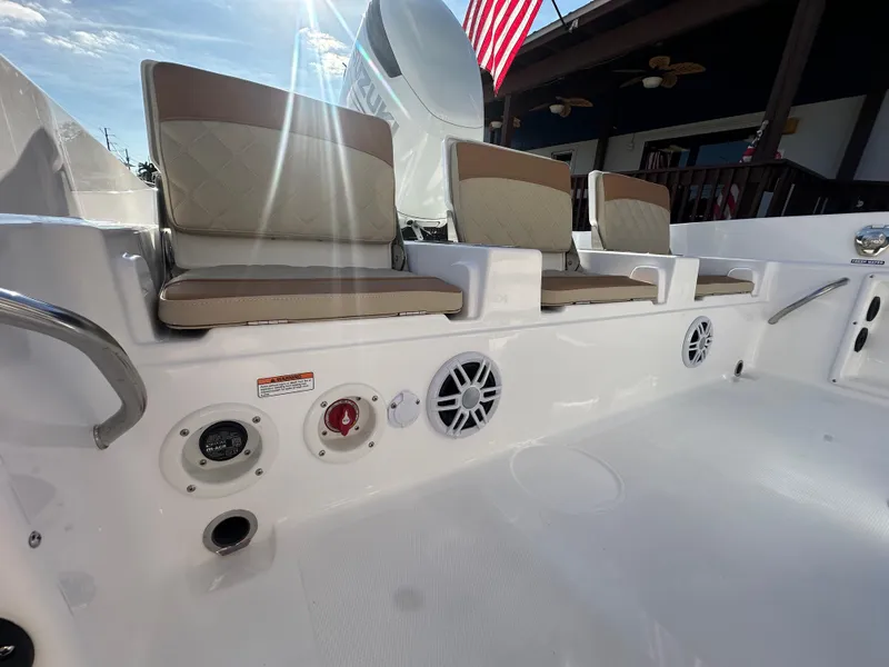 Slide: The Image of 2025 NauticStar 231 Hybrid boat interior with cushioned seating and control panel. - 29